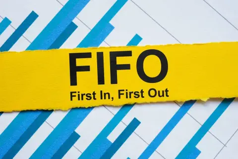 Żółty pasek z napisem FIFO (First In, First Out) na tle wykresu. Zasada FIFO w praktyce.